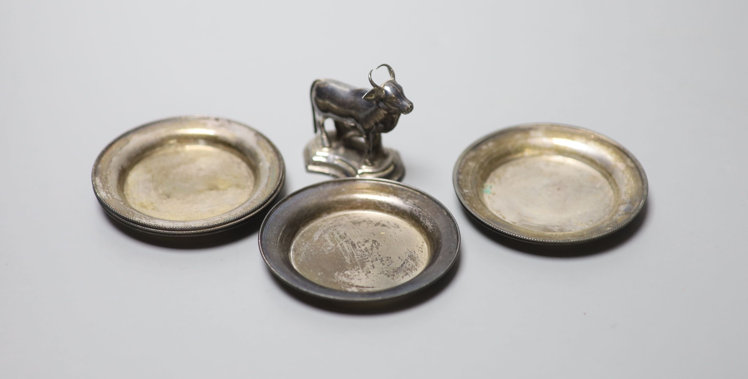 A set of six Polish 800 standard white metal small dishes, 71mm, 99 grams and a miniature model of a cow and calf.